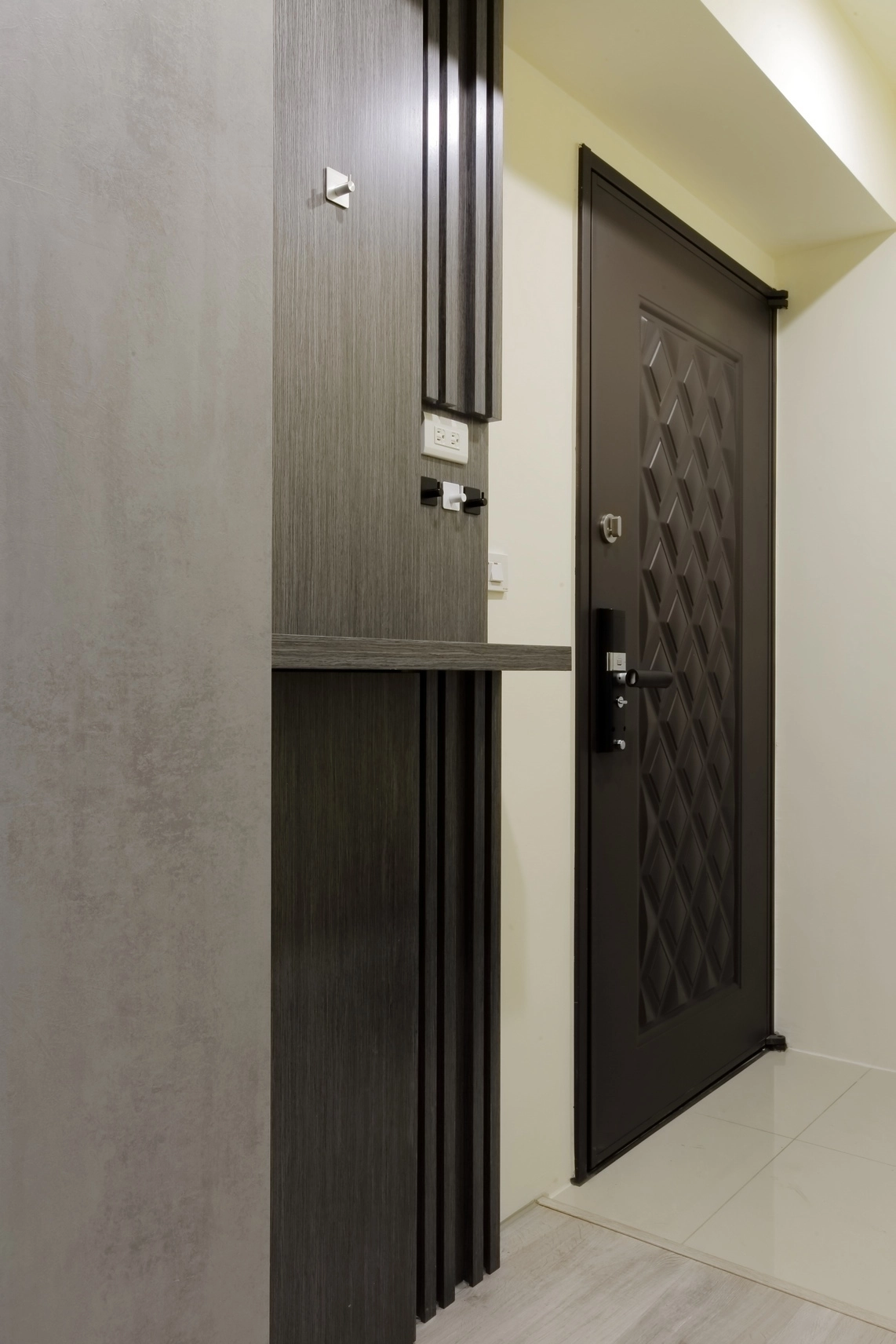 高雄小港新成屋。現代簡約風格，淺灰色系打造靜謐，玄關格柵修飾電器櫃。