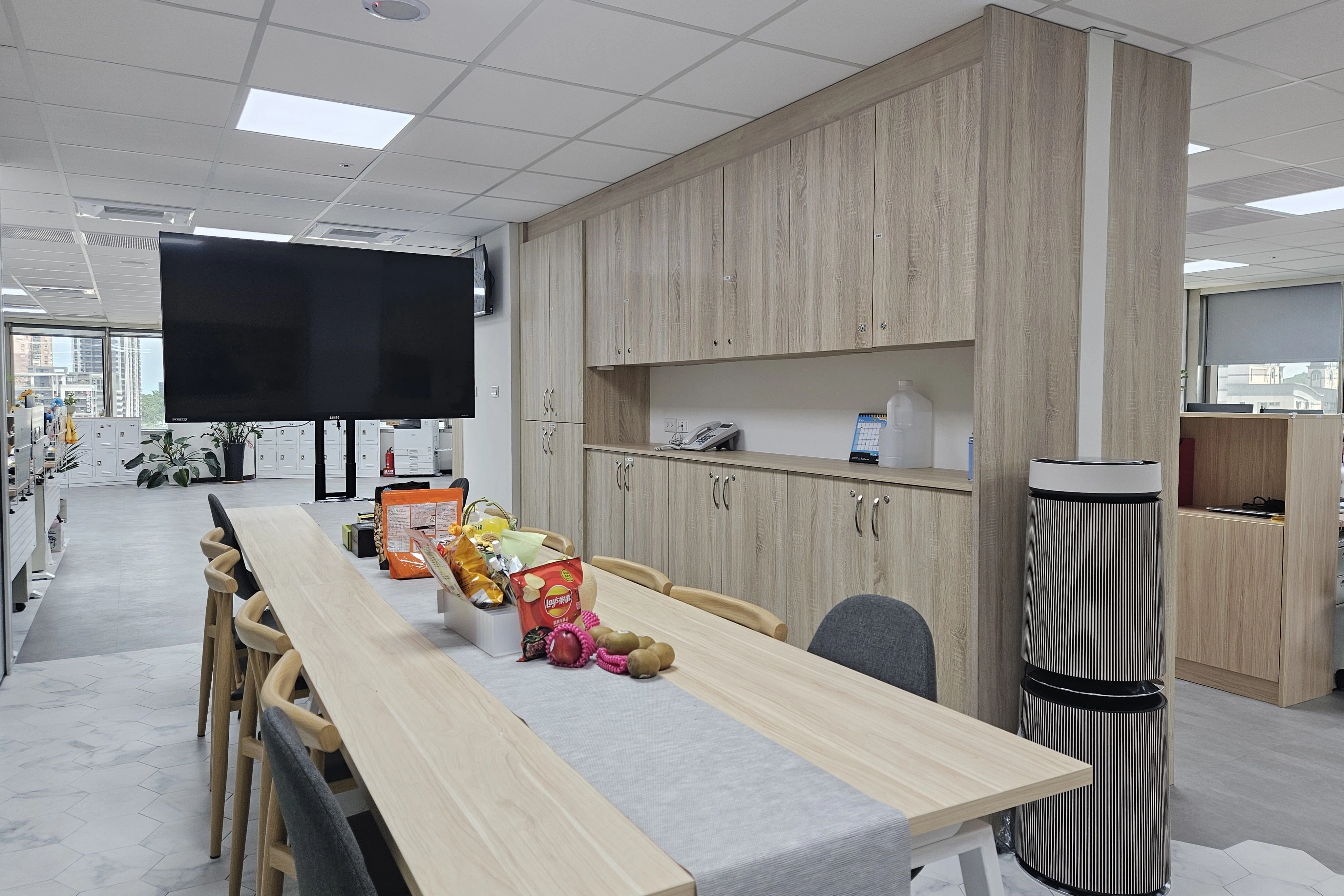 系統櫃設計高效收納，沿牆面設有大量木紋櫃體提供完善儲物機能保持環境整潔。