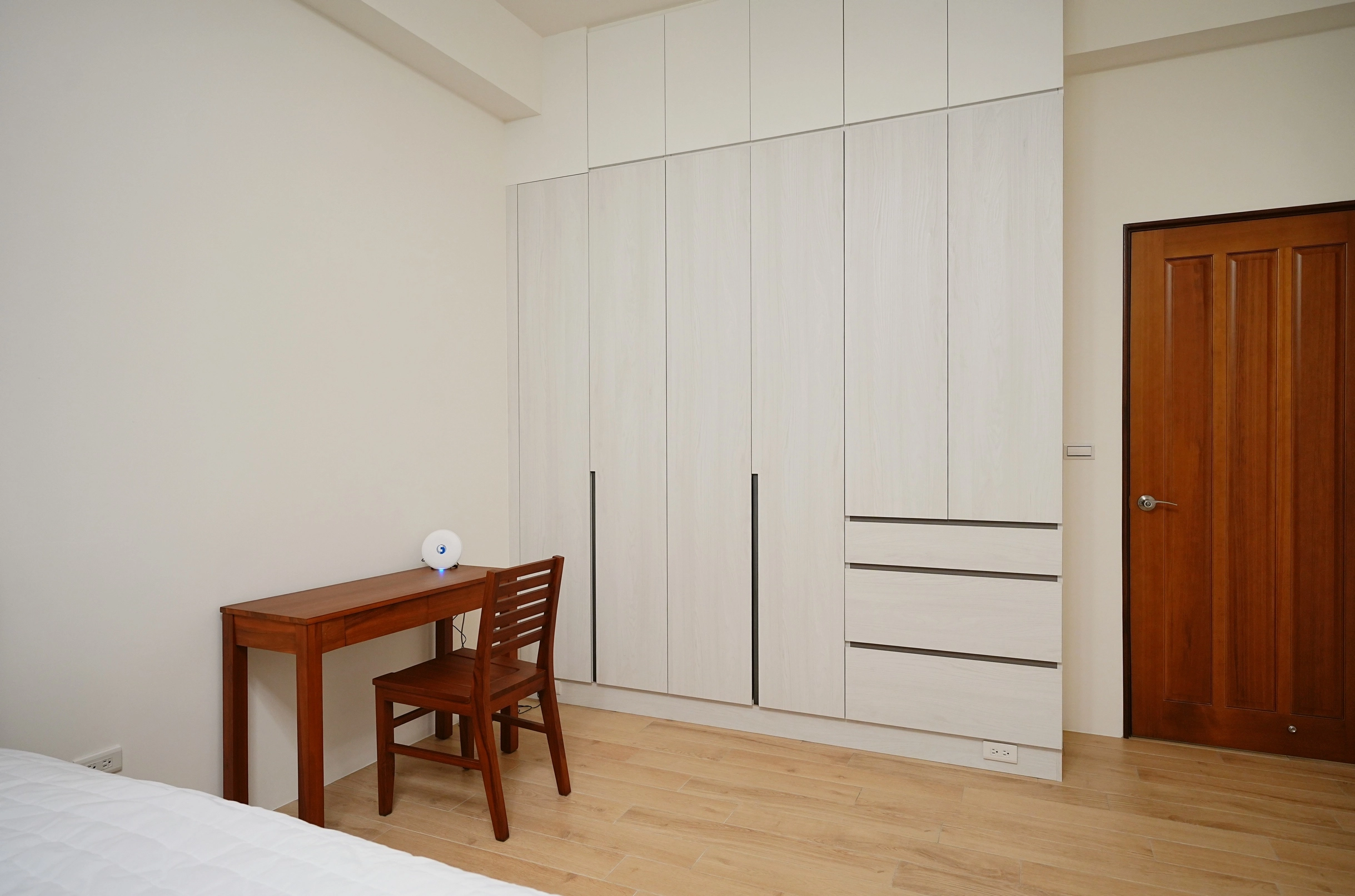 德盈設計:客臥空間融合跳色系統櫃與細緻木紋材質,精準的配色配置,打造機能與美感兼具的臥室。