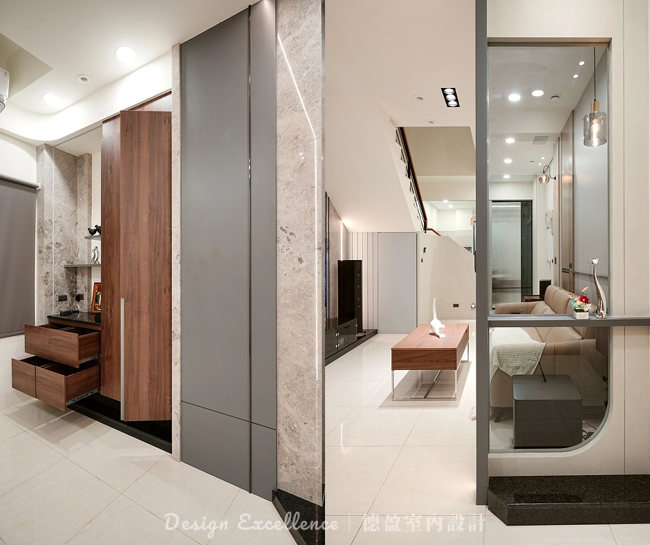 玄關系統懸吊櫃配大理石檯面,結合木作黑透玻隔屏,打造大器進門視覺。